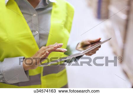Cropped shot of female warehouse worker using digital tablet View Large Photo Image Stock Image - Cropped shot of female warehouse worker using digital tablet. Fotosearch
