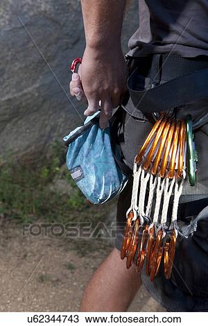 Cropped shot of young male climber attaching carabiners to belt View Large Photo Image Stock Image - Cropped shot of young male climber attaching carabiners to belt. Fotosearch