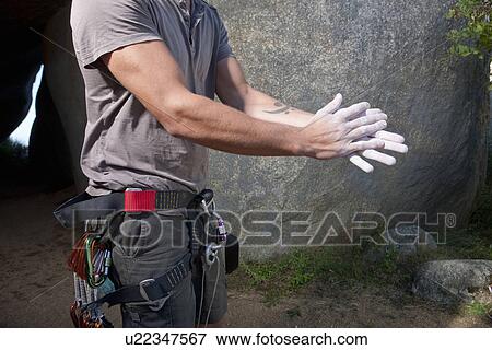 Cropped shot of young male climber rubbing sports chalk on hands View Large Photo Image Stock Photo - Cropped shot of young male climber rubbing sports chalk on hands. Fotosearch