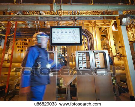 Engineer passing digital display in power station View Large Photo Image Stock Image - Engineer passing digital display in power station. Fotosearch