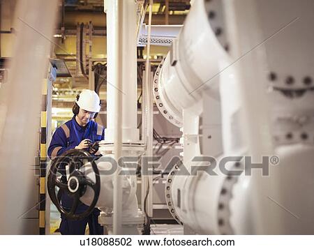 Engineer taking reading in power station View Large Photo Image Stock Image - Engineer taking reading in power station. Fotosearch