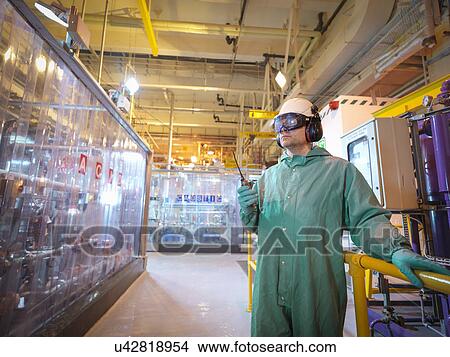 Picture - Engineer working in acid and caustic plant in power station. Fotosearch