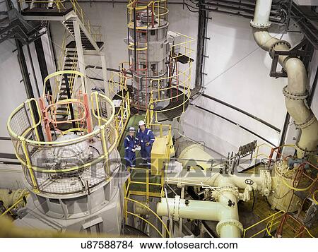 Engineers in seawater pumping station of power station, high angle view View Large Photo Image Picture - Engineers in seawater pumping station of power station, high angle view. Fotosearch