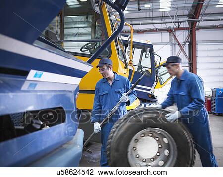 Engineers prepare to fix wheel in truck repair factory View Large Photo Image Stock Image - Engineers prepare to fix wheel in truck repair factory. Fotosearch