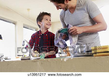Father and son doing washing up View Large Photo Image Stock Photo - Father and son doing washing up. Fotosearch