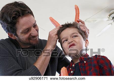 Father and son with carrot horns View Large Photo Image Stock Image - Father and son with carrot horns. Fotosearch