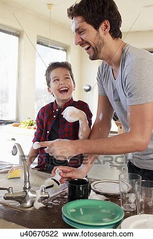 Father and son with soap suds on hands View Large Photo Image Stock Image - Father and son with soap suds on hands. Fotosearch