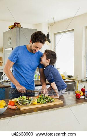 Father and young son preparing vegetables in kitchen View Large Photo Image Stock Image - Father and young son preparing vegetables in kitchen. Fotosearch
