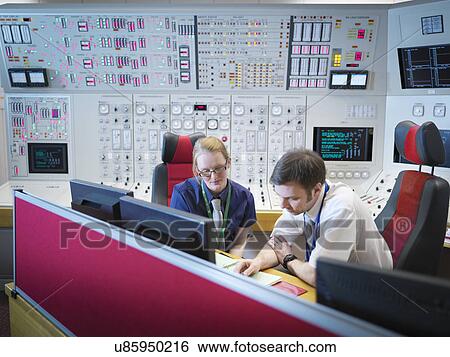 Stock Photograph - Female operator and trainee in nuclear power station control room simulator. Fotosearch