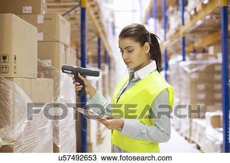 Female warehouse worker using barcode reader View Large Photo Image Stock Image - Female warehouse worker using barcode reader. Fotosearch