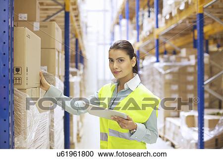 Female warehouse worker with digital tablet View Large Photo Image Stock Image - Female warehouse worker with digital tablet. Fotosearch