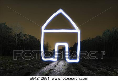 Stock Image - Field landscape at night with light painted drawing of house. Fotosearch