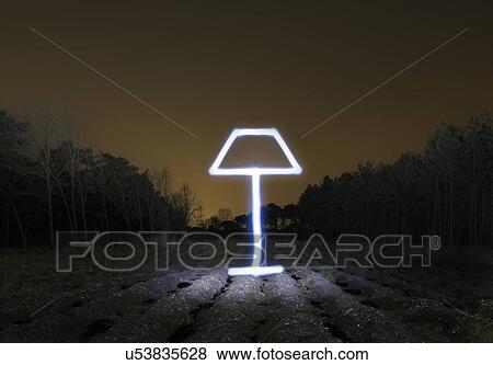 Stock Photo - Field landscape at night with light painted drawing of lamp. Fotosearch