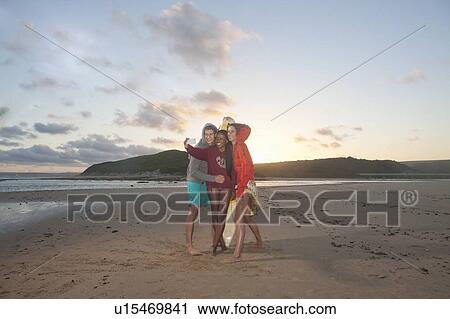 Friends on beach taking self portrait photograph View Large Photo Image Stock Image - Friends on beach taking self portrait photograph. Fotosearch