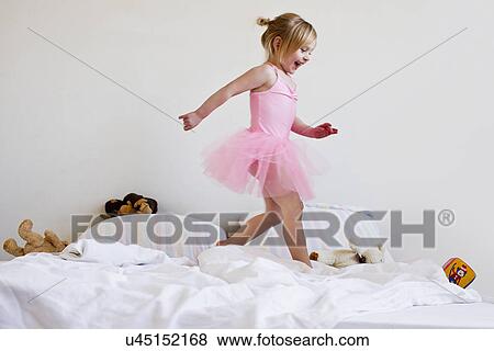 Girl dressed as ballet dancer running on bed View Large Photo Image Stock Photo - Girl dressed as ballet dancer running on bed. Fotosearch
