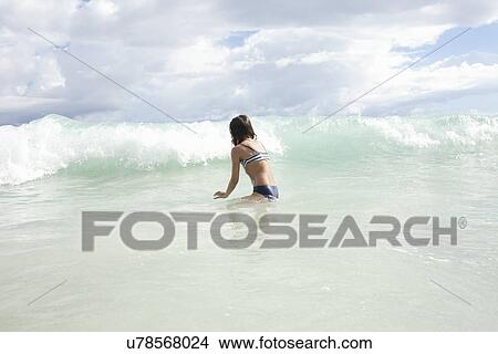 Girl playing in sea View Large Photo Image Picture - Girl playing in sea. Fotosearch