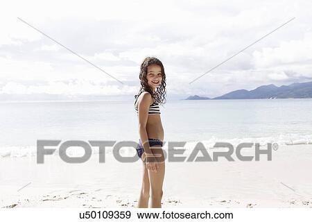 Girl standing on beach in Seychelles View Large Photo Image Stock Photo - Girl standing on beach in Seychelles. Fotosearch