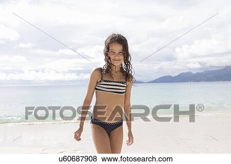 Girl standing on beach in Seychelles View Large Photo Image Stock Photo - Girl standing on beach in Seychelles. Fotosearch