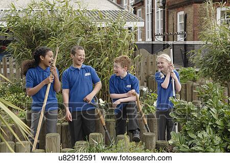 Group of four school children with gardening tools View Large Photo Image Stock Image - Group of four school children with gardening tools. Fotosearch