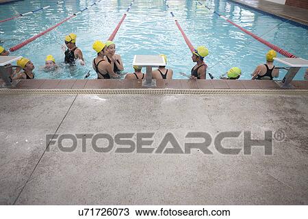 Large group of schoolgirls taking a break in swimming pool View Large Photo Image Stock Image - Large group of schoolgirls taking a break in swimming pool. Fotosearch