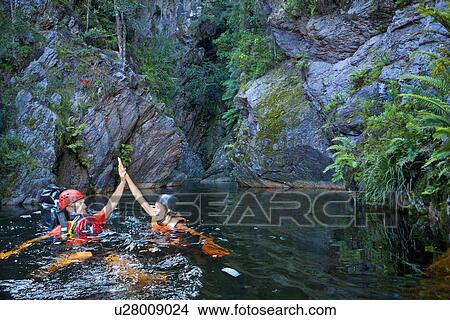 Man and woman canyoneering View Large Photo Image Picture - Man and woman canyoneering. Fotosearch