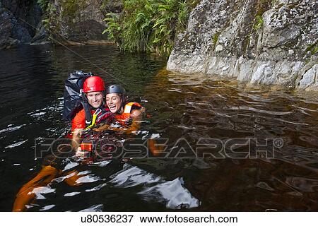 Man and woman canyoneering View Large Photo Image Stock Photo - Man and woman canyoneering. Fotosearch