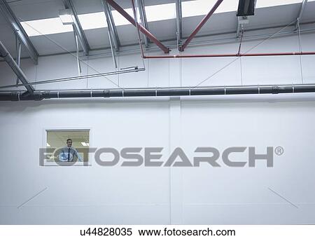 Manager inspecting truck repair factory from office window View Large Photo Image Stock Photography - Manager inspecting truck repair factory from office window. Fotosearch