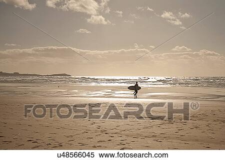 Stock Photography - Mature man carrying surfboard. Fotosearch