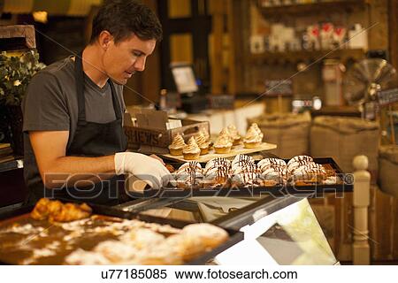 Stock Photography - Mature man with tray of fresh pastries. Fotosearch