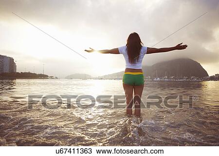Mature woman with arms outstretched on Botafogo beach, Rio De Janeiro, Brazil View Large Photo Image Stock Image - Mature woman with arms outstretched on Botafogo beach, Rio De Janeiro, Brazil. Fotosearch