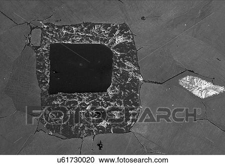 Stock Image - Meteorite found in Joshua Tree, cross sectioned, polished, etched, back-scatter SEM. Fotosearch
