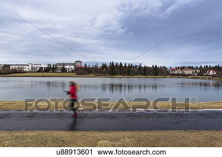 Mid adult woman out running on lake path, Reykjavic, Iceland View Large Photo Image Stock Image - Mid adult woman out running on lake path, Reykjavic, Iceland. Fotosearch