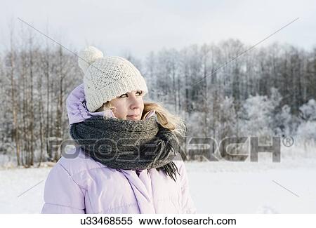 Mid adult woman wearing winter clothing in snow covered field View Large Photo Image Stock Photography - Mid adult woman wearing winter clothing in snow covered field. Fotosearch