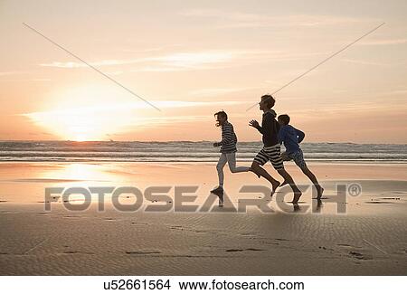 Mother and sons running on beach View Large Photo Image Picture - Mother and sons running on beach. Fotosearch
