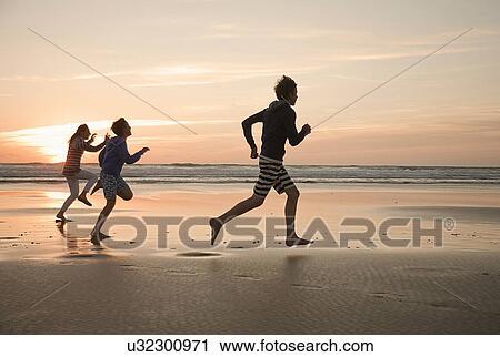 Mother and sons running on beach View Large Photo Image Stock Image - Mother and sons running on beach. Fotosearch