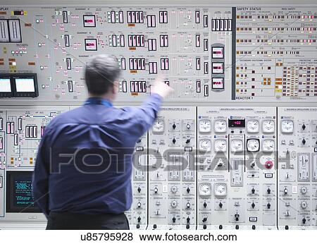 Stock Photo - Operator adjusting controls in nuclear power station control room simulator. Fotosearch
