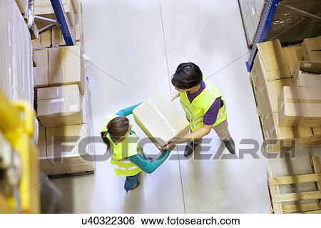 Stock Photograph - Overhead view of workers in distribution warehouse. Fotosearch