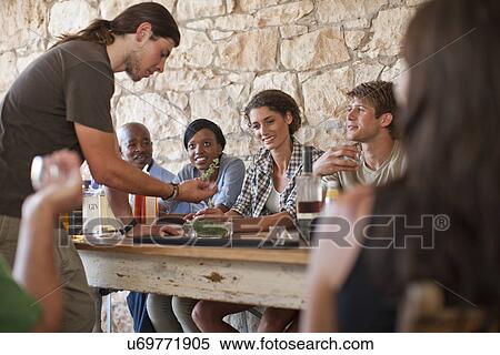 People sitting around table, tasting drinks View Large Photo Image Stock Photography - People sitting around table, tasting drinks. Fotosearch