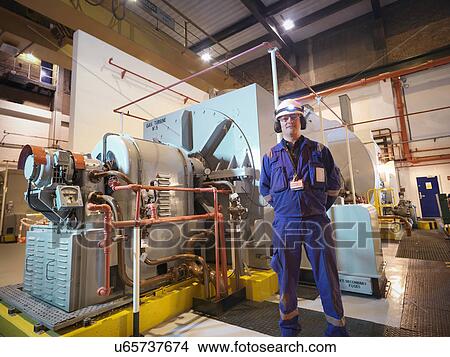 Portrait of engineer in generator room of power station View Large Photo Image Picture - Portrait of engineer in generator room of power station. Fotosearch