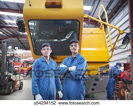 Stock Image - Portrait of engineers in truck repair factory. Fotosearch