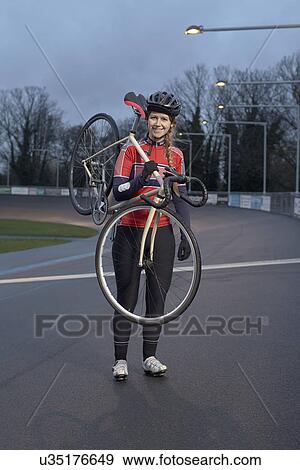 Portrait of female cyclist with cycle at velodrome View Large Photo Image Stock Photo - Portrait of female cyclist with cycle at velodrome. Fotosearch