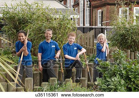 Portrait of four school children with gardening tools View Large Photo Image Stock Image - Portrait of four school children with gardening tools. Fotosearch