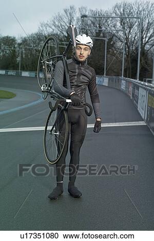 Portrait of male cyclist with cycle on shoulder at velodrome View Large Photo Image Stock Image - Portrait of male cyclist with cycle on shoulder at velodrome. Fotosearch