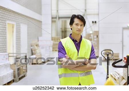 Portrait of male warehouse worker in distribution warehouse View Large Photo Image Stock Image - Portrait of male warehouse worker in distribution warehouse. Fotosearch