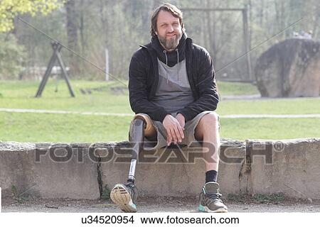 Portrait of man with prosthesis leg in park View Large Photo Image Picture - Portrait of man with prosthesis leg in park. Fotosearch