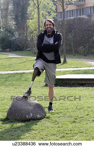 Stock Photograph - Portrait of man with prosthesis leg in park. Fotosearch