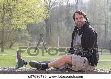 Portrait of man with prosthesis leg in park View Large Photo Image Stock Photograph - Portrait of man with prosthesis leg in park. Fotosearch