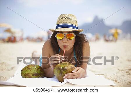 Portrait of mature woman drinking from coconut, Ipanema beach, Rio De Janeiro, Brazil View Large Photo Image Stock Image - Portrait of mature woman drinking from coconut, Ipanema beach, Rio De Janeiro, Brazil. Fotosearch
