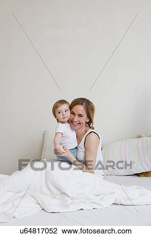 Portrait of mid adult woman and her one year old baby girl View Large Photo Image Stock Image - Portrait of mid adult woman and her one year old baby girl. Fotosearch