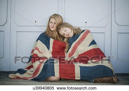 Portrait of sisters sitting on porch wrapped in union jack flag View Large Photo Image Stock Photography - Portrait of sisters sitting on porch wrapped in union jack flag. Fotosearch